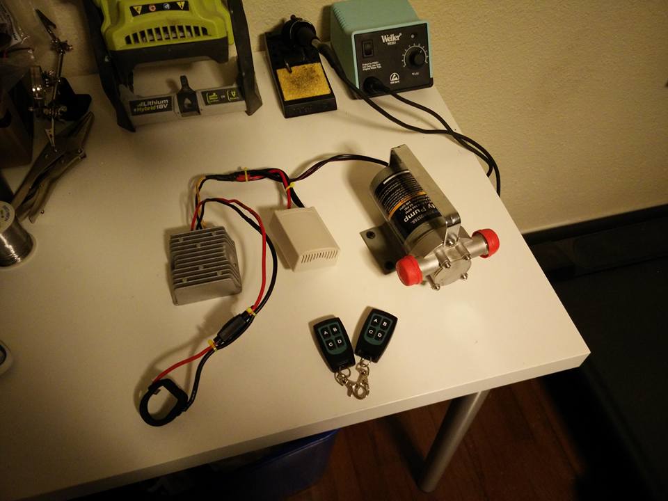 Battery powered water pump with remote wiring harness is...