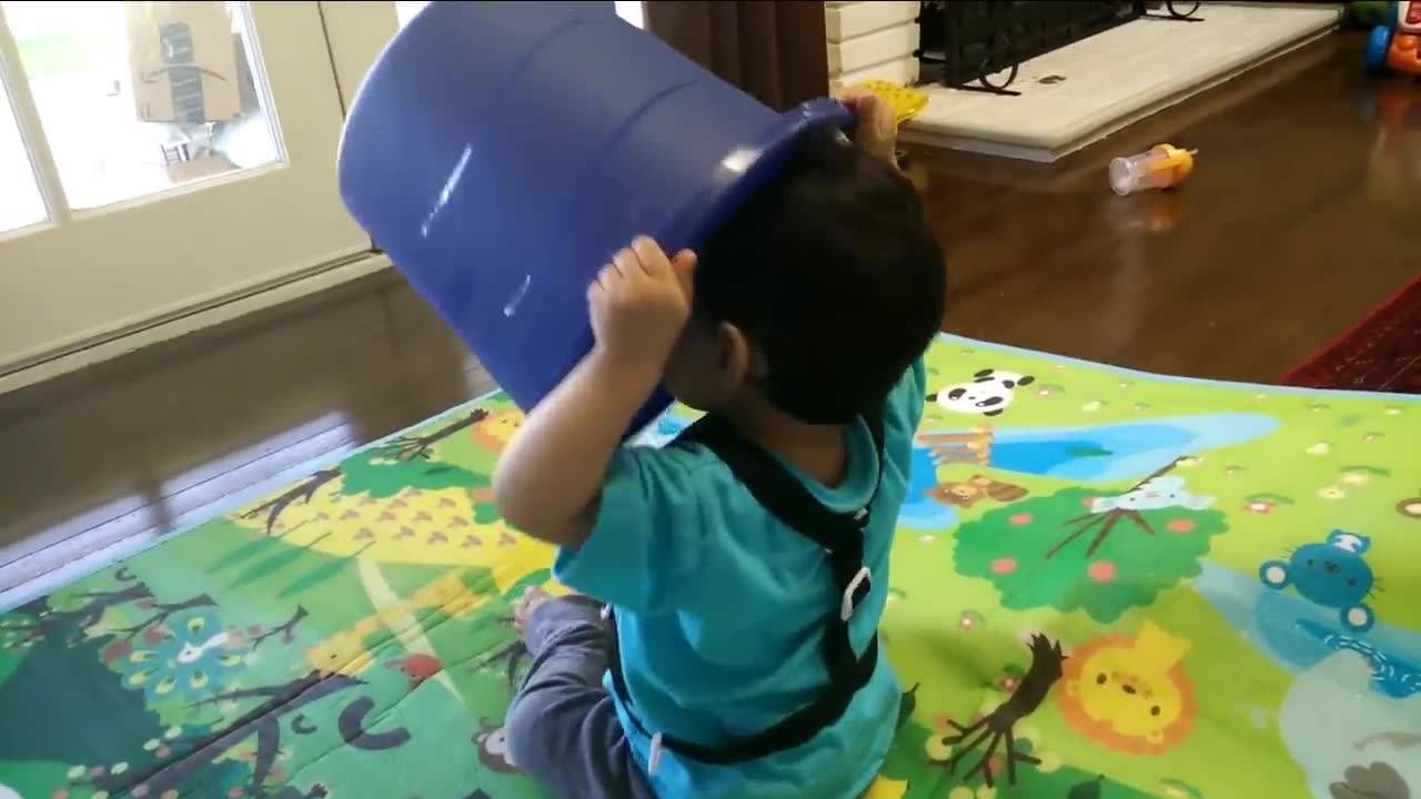 Eren playing with his blue bucket