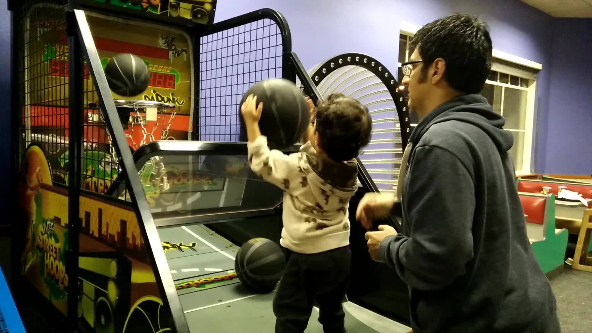 Eren playing basketball with me at Chuck E. Cheese's