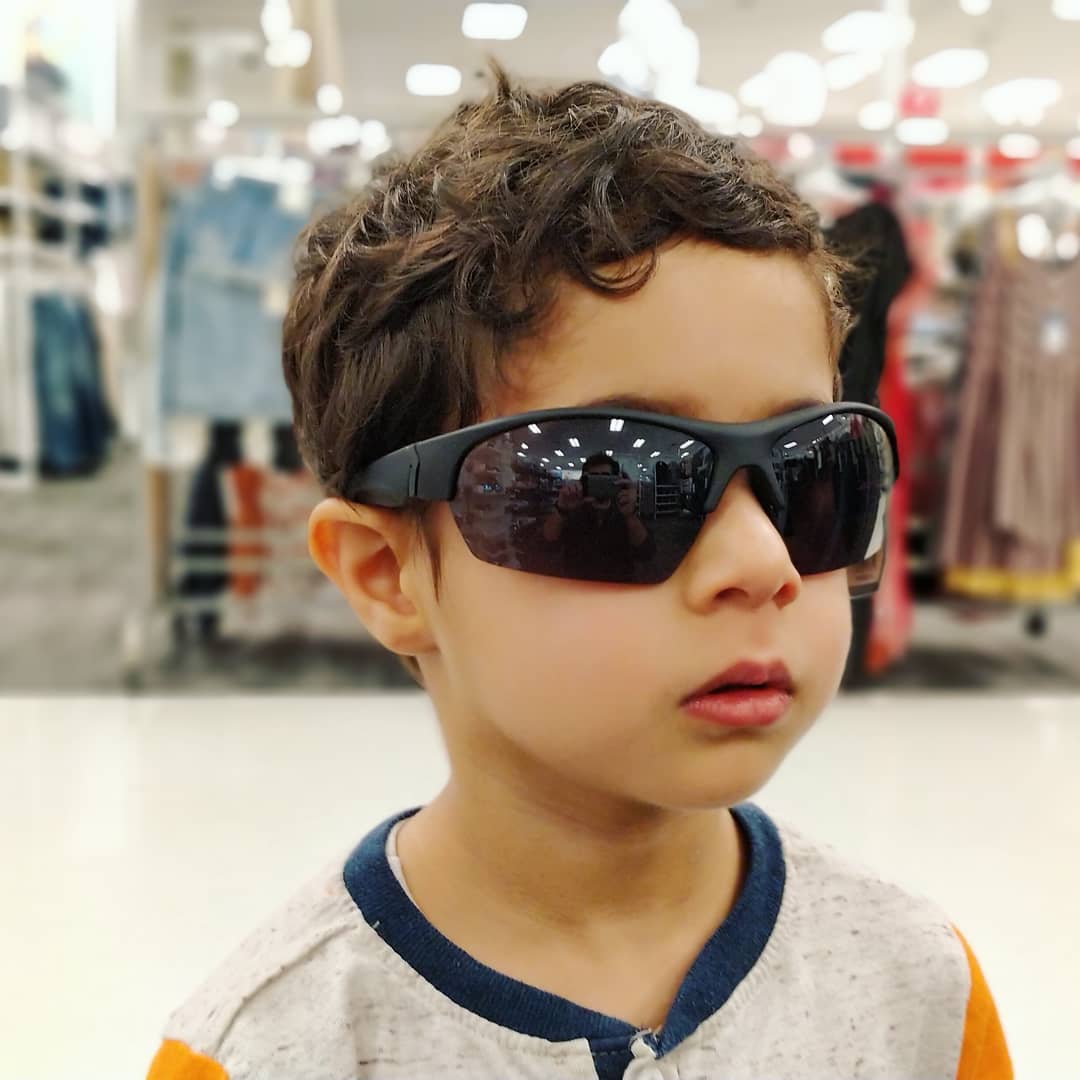 Eren trying on shades at Target
