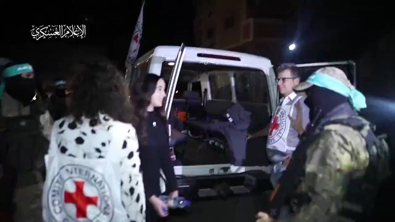 Israeli hostages giving high fives and saying goodbye to...